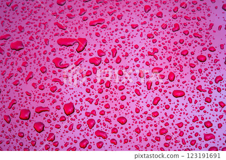 red background with texture of rain drops on purple metallic surface close-up 123191691