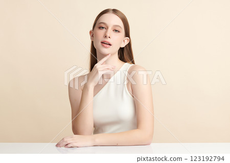 Beautiful young woman with clean fresh skin on beige background, Face care, Facial treatment, Cosmetology, beauty and spa, women portrait. 123192794