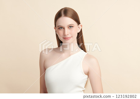 Beautiful young woman with clean fresh skin on beige background, Face care, Facial treatment, Cosmetology, beauty and spa, women portrait. Beautiful young woman with clean fresh skin on beige background, Face care, Facial treatment, Cosmetology, beauty and spa, women portrait. 123192802