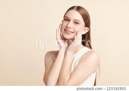 Beautiful young woman with clean fresh skin on beige background, Face care, Facial treatment, Cosmetology, beauty and spa, women portrait. Beautiful young woman with clean fresh skin on beige background, Face care, Facial treatment, Cosmetology, beauty and spa, women portrait. 123192803