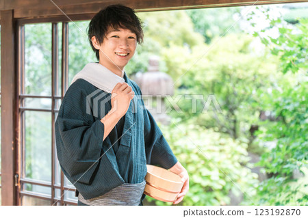 A man wearing a yukata staying at a hot spring, a hot spring inn, or a public bath A man wearing a yukata staying at a hot spring, a hot spring inn, or a public bath 123192870