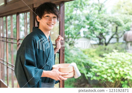 A man wearing a yukata staying at a hot spring, a hot spring inn, or a public bath A man wearing a yukata staying at a hot spring, a hot spring inn, or a public bath 123192871