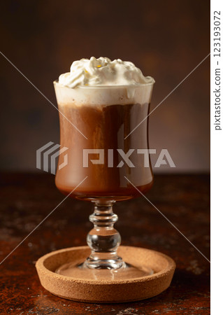 Hot chocolate with whipped cream in a glass mug. 123193072