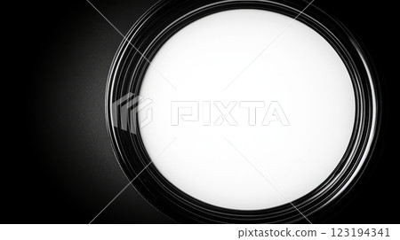 Circular light fixture casting a soft glow in a darkened room Circular light fixture casting a soft glow in a darkened room 123194341