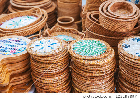 wooden kitchen utensils and handmade wicker baskets and containers on Asian market in Vietnam 123195897
