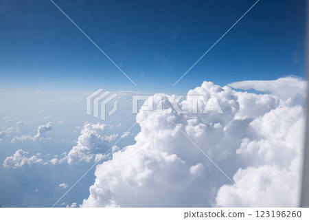 View from window of the plane above expanse of fluffy white clouds 123196260