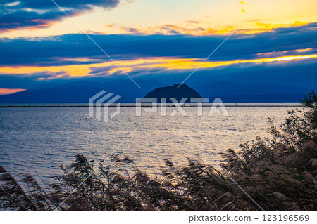 [Lake Biwa scenery] The fantastic Chikubu Island floating in the autumn evening scenery 123196569