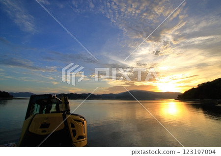 A backhoe standing by the sea after work A backhoe standing by the sea after work 123197004