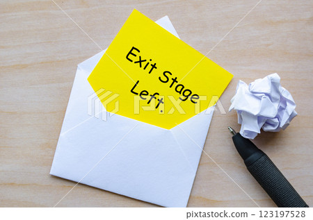 Exit Stage Left text on yellow paper in an envelope. Resignation concept. 123197528
