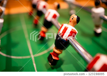 Close up of table foosball game with player figurines on green field 123198095