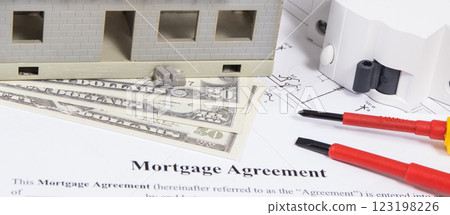 Unfinished house, mortgage agreement form, dollars and equipments for building home 123198226