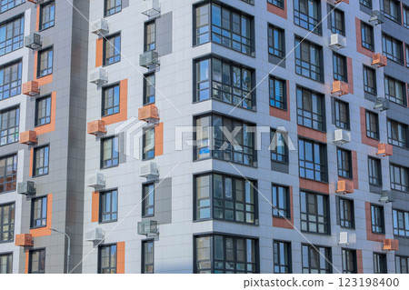 The concept of modern architecture, a residential complex, an apartment building for living. Close-up of the corner of the house in the camera multi-storey, apartment building in gray and white tones The concept of modern architecture, a residential complex, an apartment building for living. Close-up of the corner of the house in the camera multi-storey, apartment building in gray and white tones 123198400