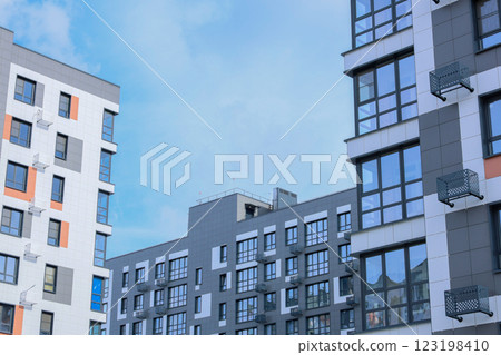 The concept of modern architecture, residential complex, apartment buildings for living. Multi-storey, apartment buildings of the residential complex in a single architecture in gray and white tones The concept of modern architecture, residential complex, apartment buildings for living. Multi-storey, apartment buildings of the residential complex in a single architecture in gray and white tones 123198410