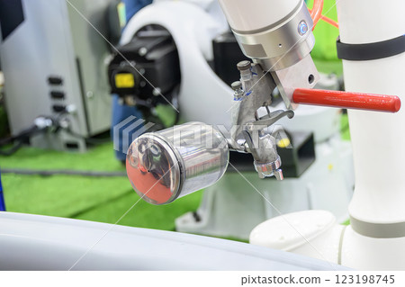Close up scene the automatic painting robot working with automotive parts. Close up scene the automatic painting robot working with automotive parts. 123198745