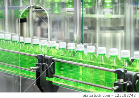 The empty drinking water bottles on the conveyor belt for filling process. The empty drinking water bottles on the conveyor belt for filling process. 123198748