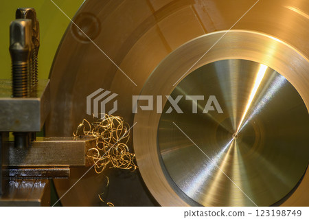 Closeup scene the lathe machine finish cut the brass parts by lathe tools. Closeup scene the lathe machine finish cut the brass parts by lathe tools. 123198749