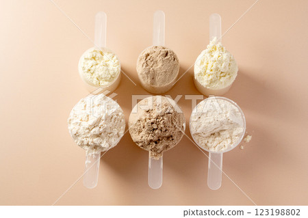 Protein powder in scoops. Different flavours of whey protein powder, copy space. 123198802