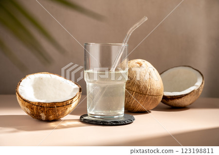 Fresh coconut water in a glass with straw 123198811