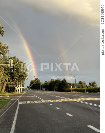 Double rainbow over empty road at sunset 123198943