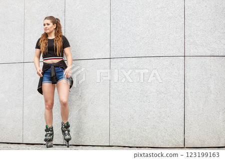 Young woman riding roller skates 123199163