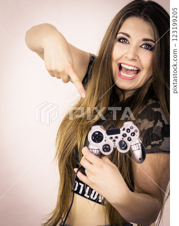 Gamer woman holding gaming pad Gamer woman holding gaming pad 123199205