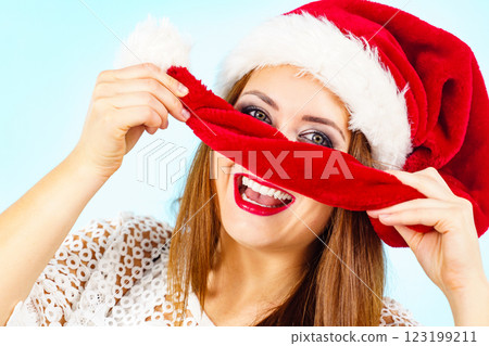 Happy woman in christmas santa hat Happy woman in christmas santa hat 123199211