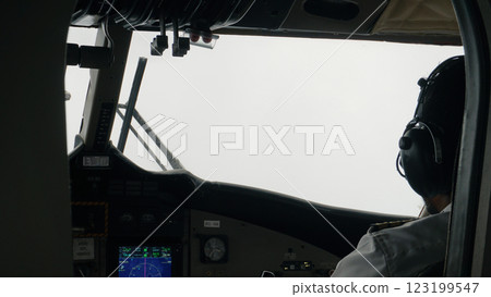 Pilot navigating airplane through dense fog in the cockpit 123199547