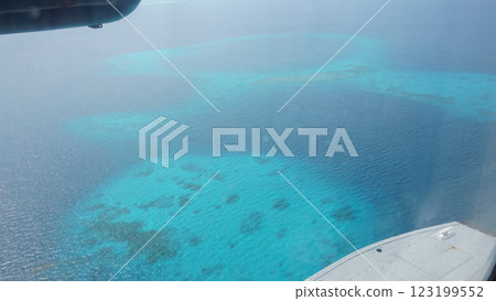 Flying over a tropical coral reef in turquoise water 123199552
