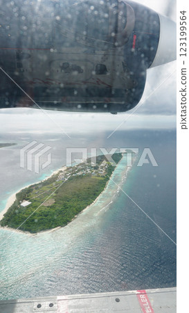 Flying over a tropical island in the maldives 123199564