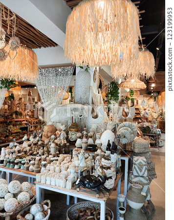 Rattan round table mats decorated with shells and rattan bottle holders at a street shop. Bali, Indonesia. 123199953