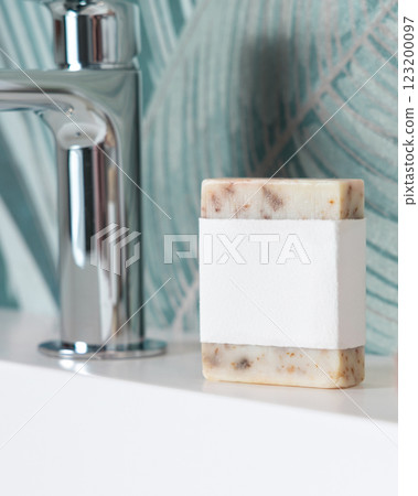 Beige soap with blank label on basin near faucet in tropical bathroom close up, mockup Beige soap with blank label on basin near faucet in tropical bathroom close up, mockup 123200097