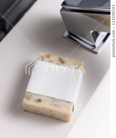 Beige soap with blank label on washbasin near faucet close up, mockup. Modern dark grey bathroom 123200101