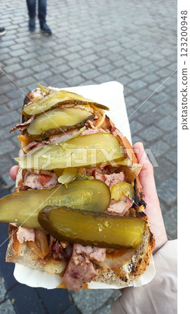 Large open-faced sandwich with grilled meat 123200948
