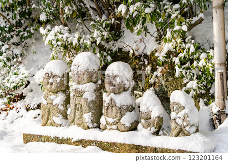 Snow-covered Jizo statue 123201164