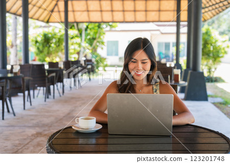 Young happy woman using laptop computer in coffee shop Young happy woman using laptop computer in coffee shop 123201748