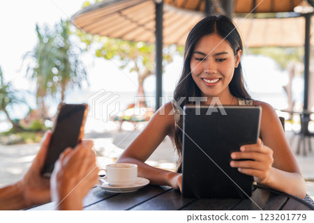 Young happy woman using tablet computer in cafe 123201779