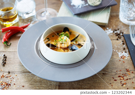 Shrimp Bisque with Seafood. King prawn, blue mussels, cod, whipped cream. Delicious traditional food closeup served for lunch in modern gourmet cuisine restaurant 123202344