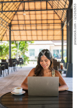 Woman using laptop computer outdoors 123202653