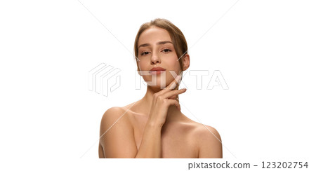 Horizontal photo of elegant woman, with bare shoulders, gently touching chin while gazing thoughtfully against white studio background. Horizontal photo of elegant woman, with bare shoulders, gently touching chin while gazing thoughtfully against white studio background. 123202754
