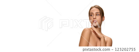 Banner. Elegant woman gently touching chin while gazing thoughtfully against white studio background with negative space to insert your text. Banner. Elegant woman gently touching chin while gazing thoughtfully against white studio background with negative space to insert your text. 123202755