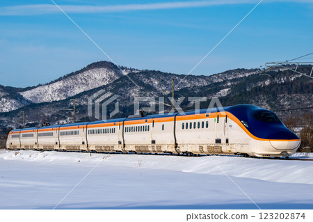 Yamagata Shinkansen Tsubasa running through snowy scenery 123202874