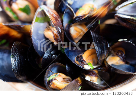 Boiled mussels in dish on dark wooden background close up 123203453
