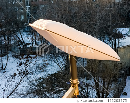 SpaceX's Starlink satellite dish is covered in snow. Starlink is disabled and does not melt snow. View from the apartment window SpaceX's Starlink satellite dish is covered in snow. Starlink is disabled and does not melt snow. View from the apartment window 123203575