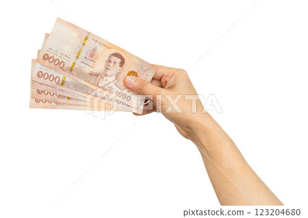 Asian woman holding Thai baht banknote money in hand isolated on white background. 123204680