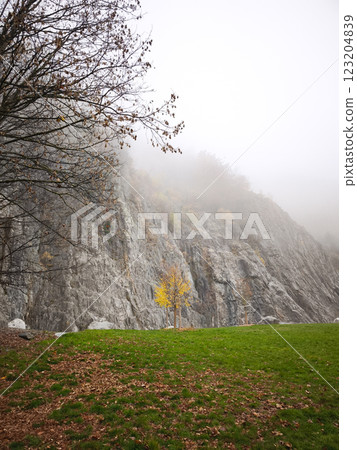 Fog rolling over mountain cliff in chamonix, france during autumn Fog rolling over mountain cliff in chamonix, france during autumn 123204839