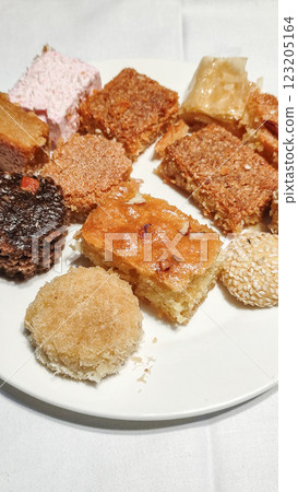 Delicious egyptian pastries showing variety of traditional sweets on white plate at marsa alam sataya resort 123205164