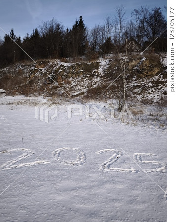 Footsteps forming number 2025 in the snow hill in prague, czechia Nature Reserve Cihelna v Bazantnici, Hloubetin 123205177