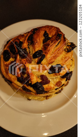 Traditional easter bread sprinkled with raisins, candied fruit, golden baked and showcasing festive holiday baking warmth copy space 123205184