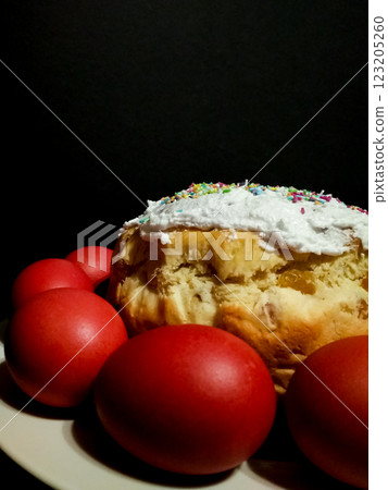 Easter cake bread Kulich red eggs, colorful sprinkles, symbolizing springtime celebration on rustic wooden background Easter cake bread Kulich red eggs, colorful sprinkles, symbolizing springtime celebration on rustic wooden background 123205260