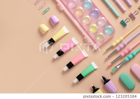 Banner with drawing supplies in green, yellow, pink and purple pastel colors on beige background. Space for your text. 123205384